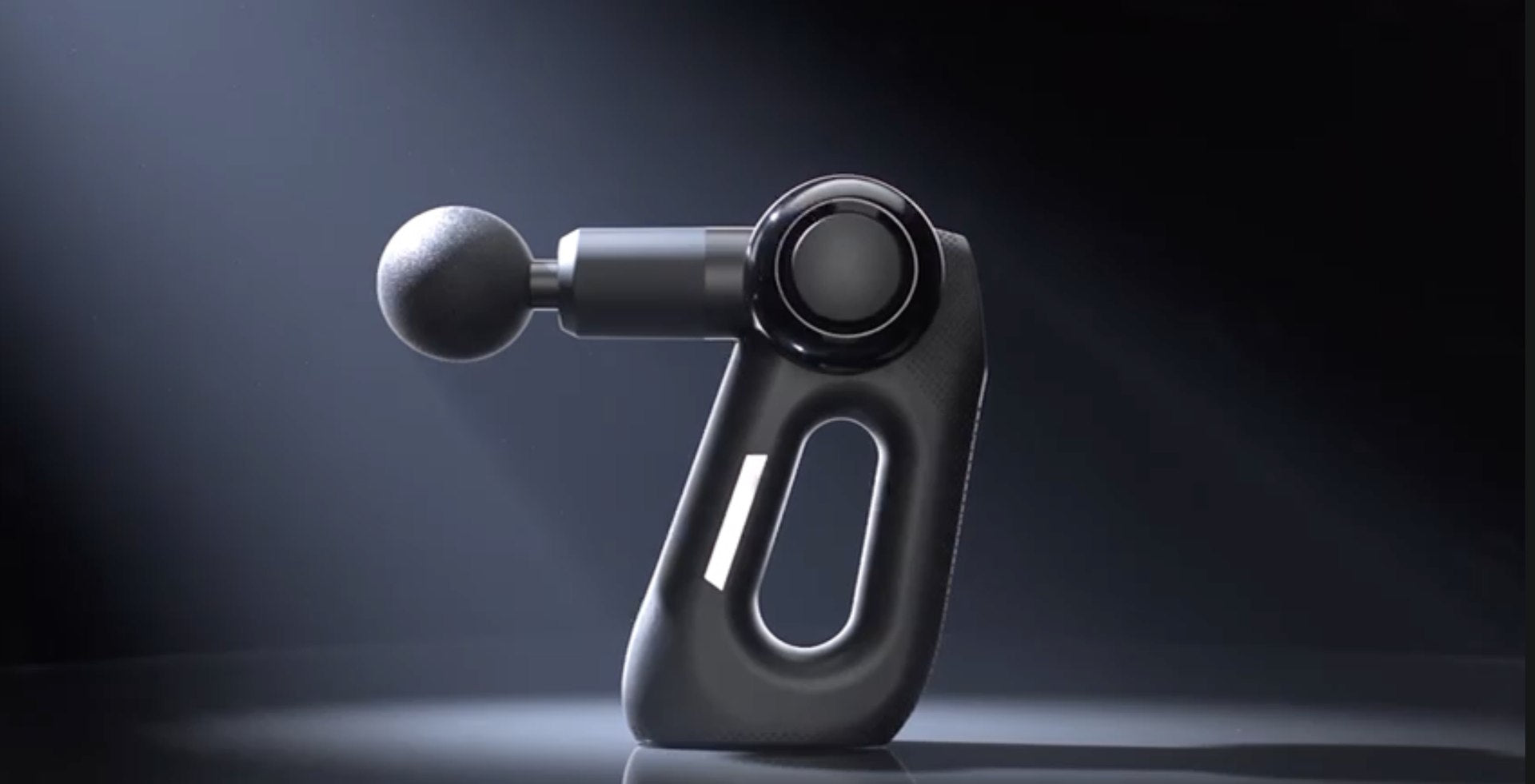 Reckx percussion massage gun on dark background